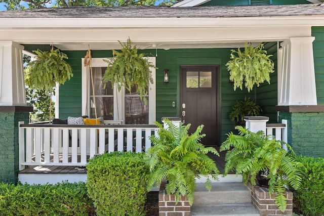 view of exterior entry with a porch