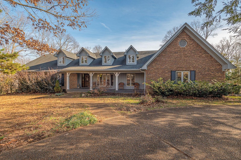 cape cod-style house with a porch