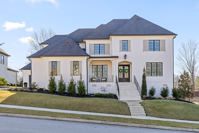 french provincial home featuring french doors and a front lawn