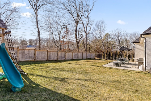 view of yard featuring a playground and a patio area