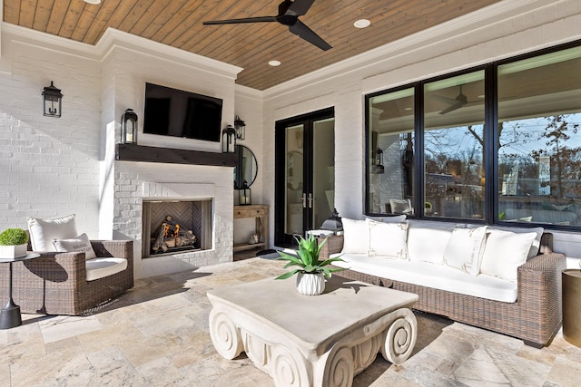 view of patio featuring ceiling fan and an outdoor fireplace