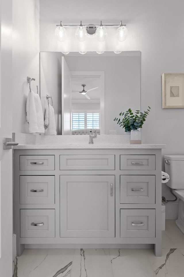 bathroom featuring vanity, ceiling fan, and toilet