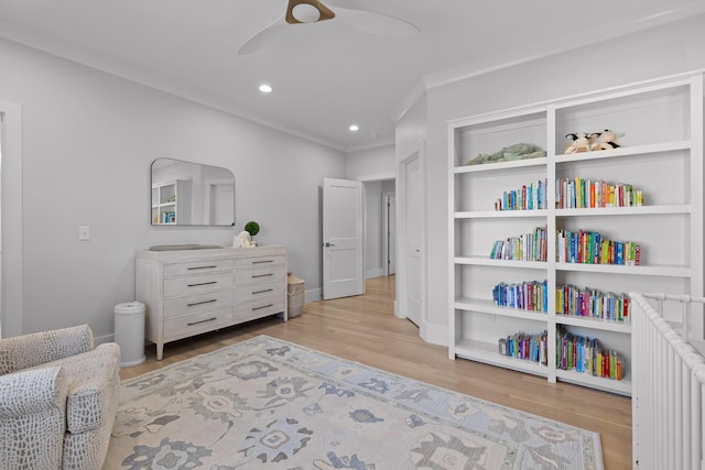 sitting room with ceiling fan, ornamental molding, and light hardwood / wood-style flooring