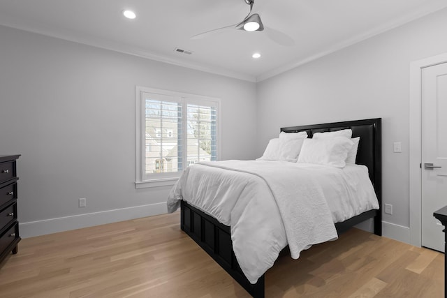 bedroom with crown molding, ceiling fan, and light hardwood / wood-style floors