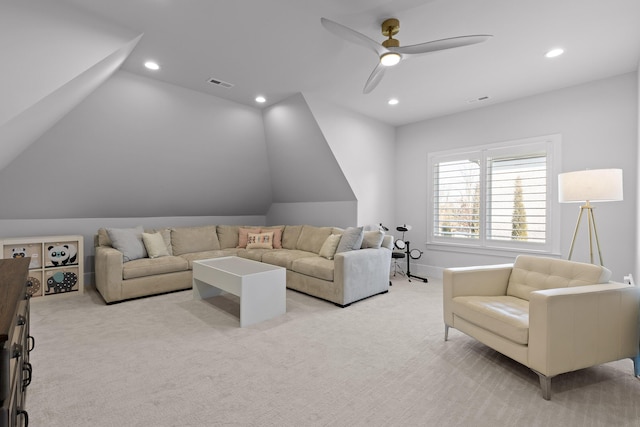 carpeted living room with ceiling fan and lofted ceiling