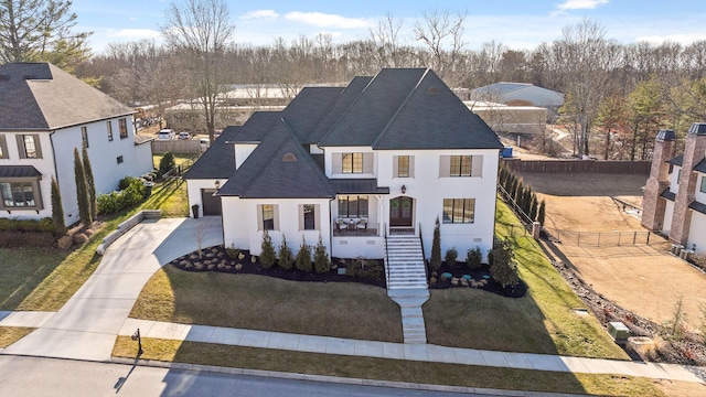 view of front of home featuring a porch, a garage, and a front yard