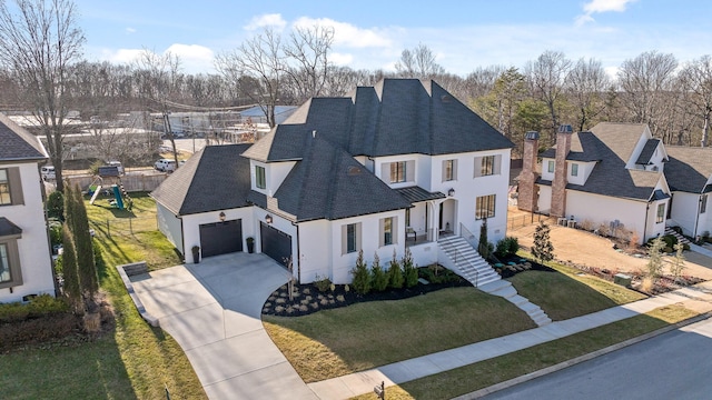 view of front of property featuring a garage and a front yard