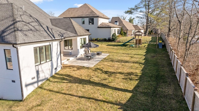 view of yard featuring a playground and a patio area