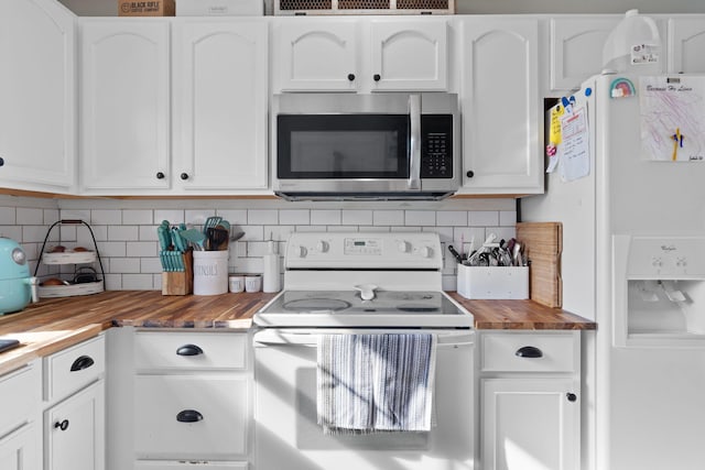 kitchen with butcher block countertops, white appliances, and white cabinets