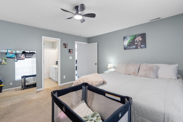 carpeted bedroom with ceiling fan and ensuite bath