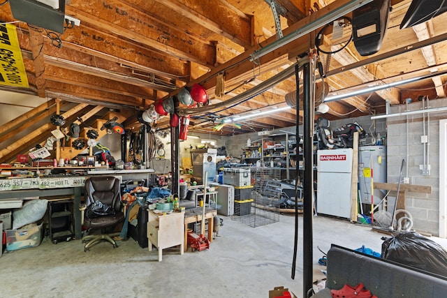 basement with a workshop area, electric water heater, and white fridge