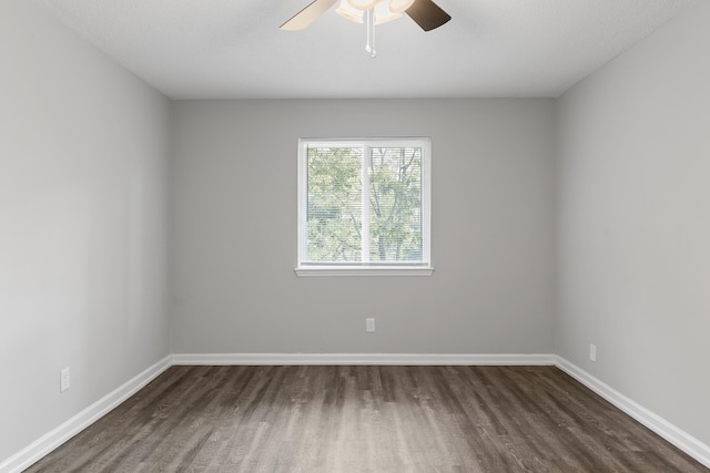 empty room featuring ceiling fan and dark hardwood / wood-style flooring