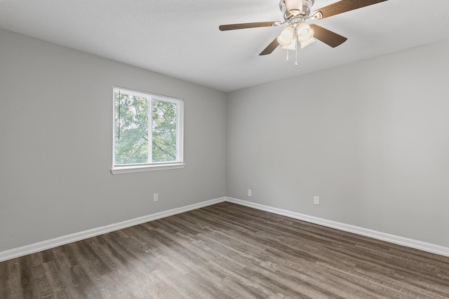 unfurnished room with dark wood-type flooring and ceiling fan