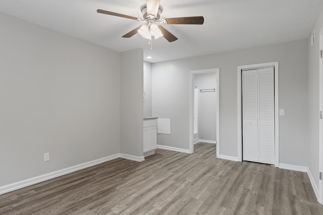 unfurnished bedroom featuring ceiling fan and light wood-type flooring