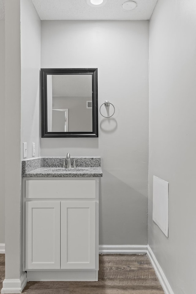 bathroom with vanity and hardwood / wood-style flooring