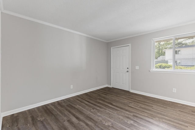 spare room with ornamental molding and dark hardwood / wood-style floors