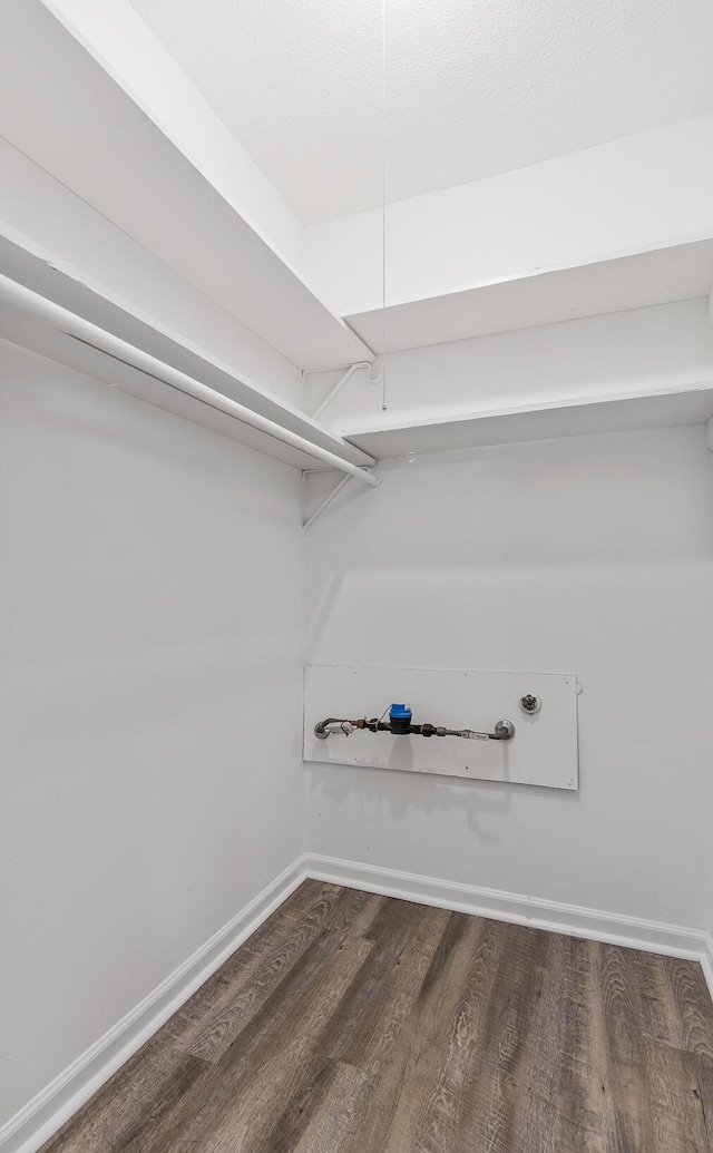 walk in closet featuring dark wood-type flooring