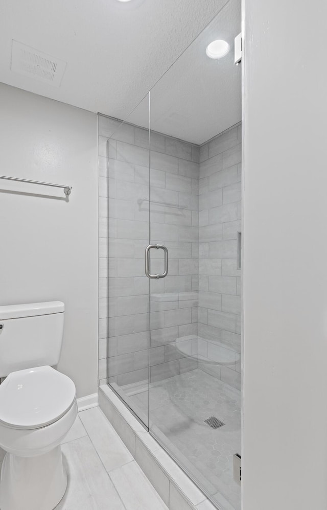 bathroom featuring an enclosed shower, tile patterned floors, and toilet