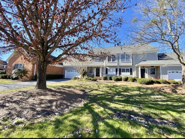 view of front of property featuring a garage and a front lawn