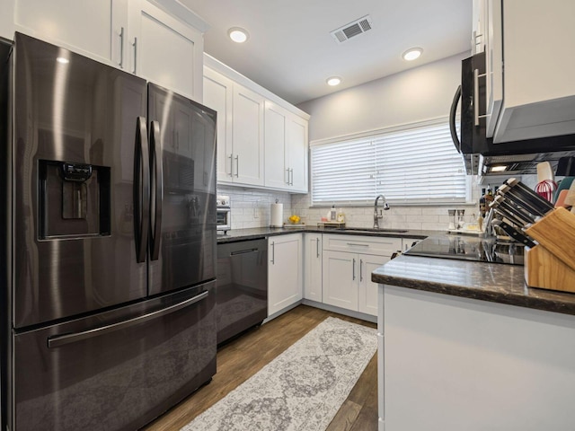 kitchen with white cabinetry, sink, decorative backsplash, and black appliances