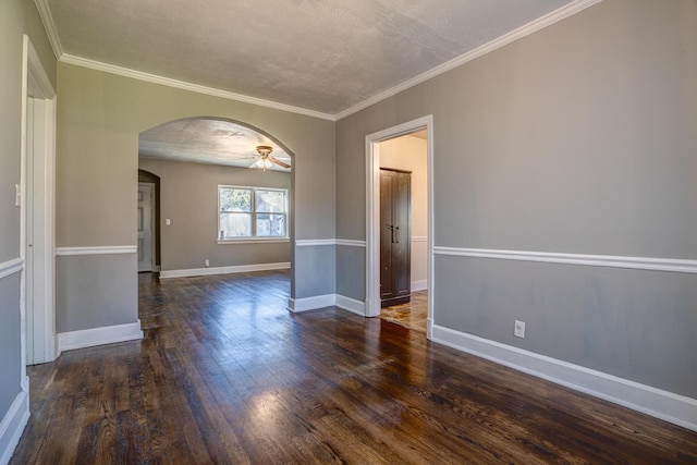 spare room featuring crown molding, dark wood-type flooring, a textured ceiling, and ceiling fan