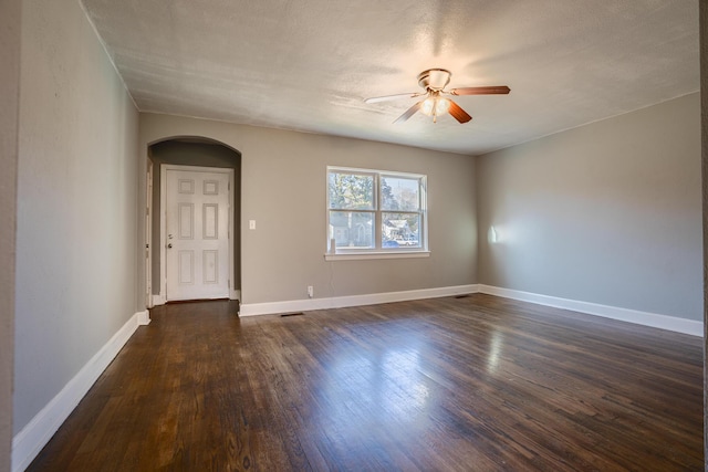 spare room featuring ceiling fan and dark hardwood / wood-style flooring