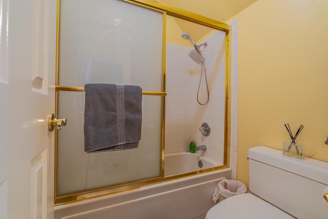 bathroom with shower / bath combination with glass door and toilet