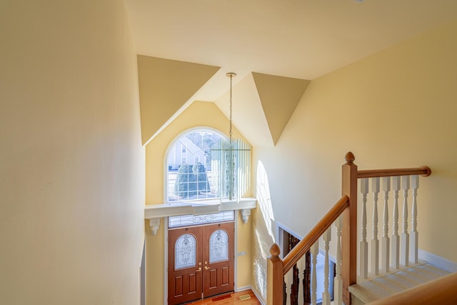 entrance foyer with high vaulted ceiling and a chandelier