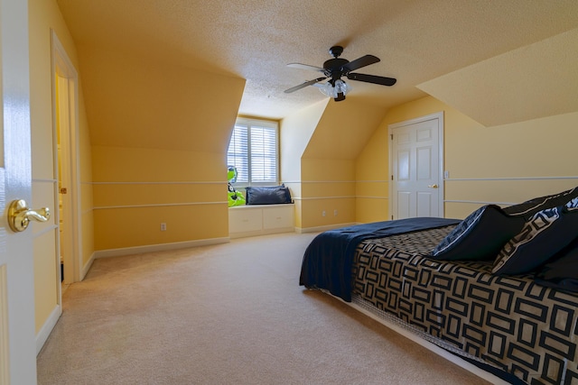 carpeted bedroom featuring ceiling fan, vaulted ceiling, and a textured ceiling