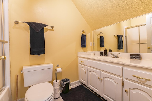 bathroom featuring lofted ceiling, vanity, toilet, and a textured ceiling