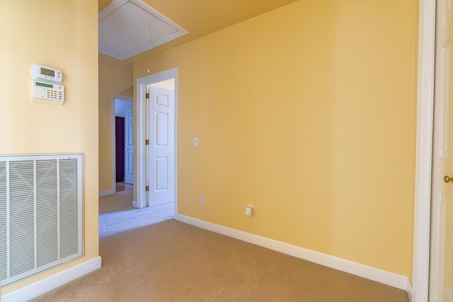 empty room featuring light carpet