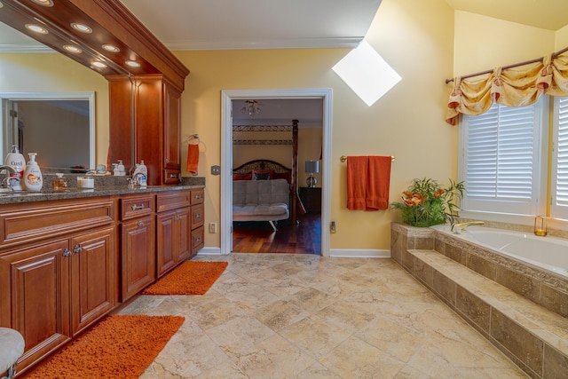 bathroom with vanity, tiled tub, and ornamental molding