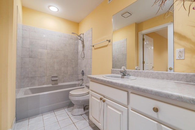 full bathroom with tiled shower / bath, vanity, toilet, and tile patterned flooring