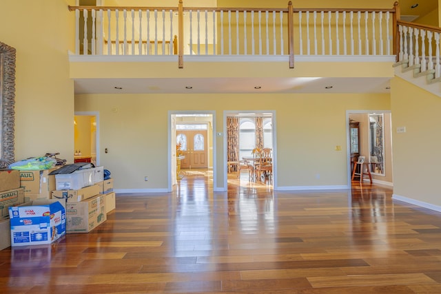 living room featuring hardwood / wood-style flooring and a high ceiling