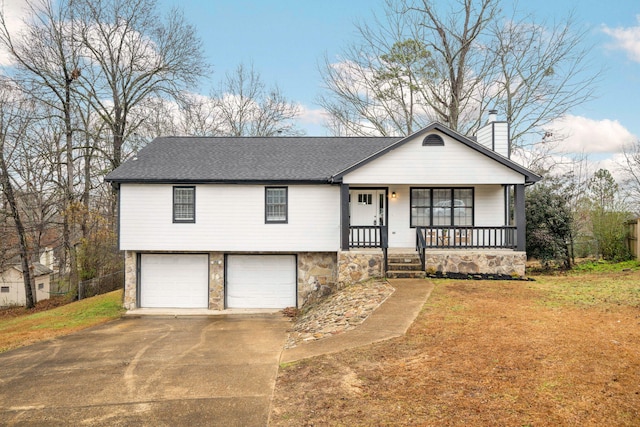 view of front facade featuring a porch, a garage, and a front lawn