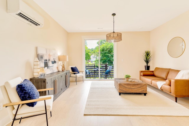 living room featuring a wall mounted air conditioner and light hardwood / wood-style flooring