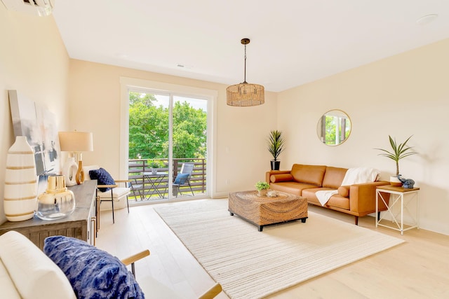 living room featuring hardwood / wood-style floors and an AC wall unit