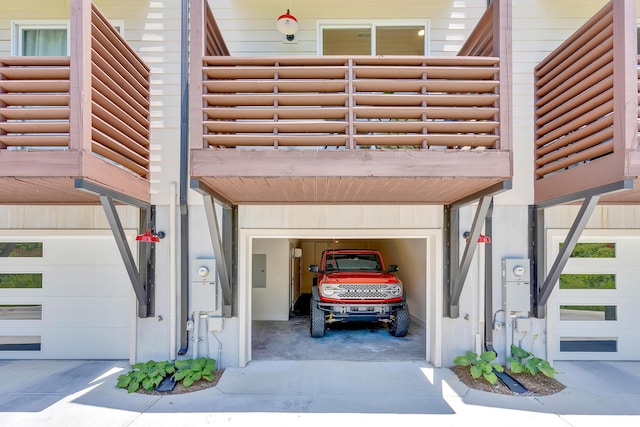 garage with a carport and electric panel