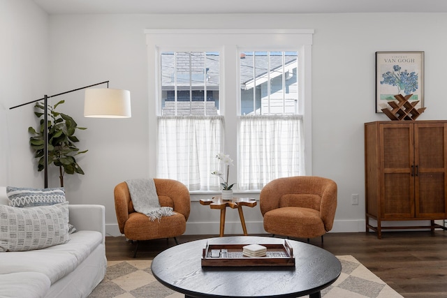 sitting room with dark wood-type flooring