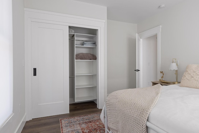 bedroom featuring dark hardwood / wood-style flooring and a closet