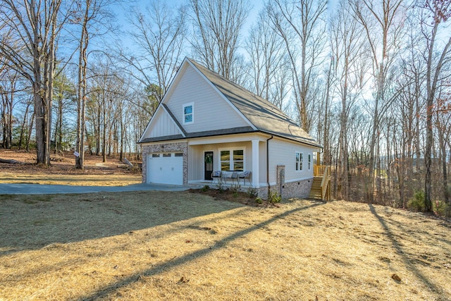 view of front of property featuring a garage and a front lawn