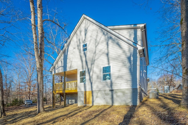 back of house featuring a balcony and central air condition unit