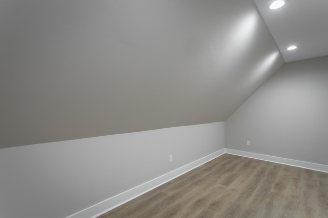 bonus room featuring light hardwood / wood-style flooring and vaulted ceiling