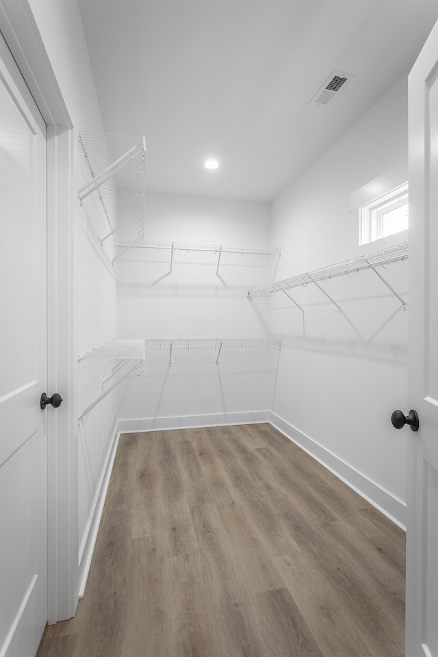 walk in closet featuring hardwood / wood-style floors