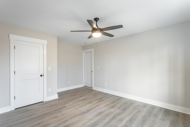 unfurnished room featuring ceiling fan and light wood-type flooring