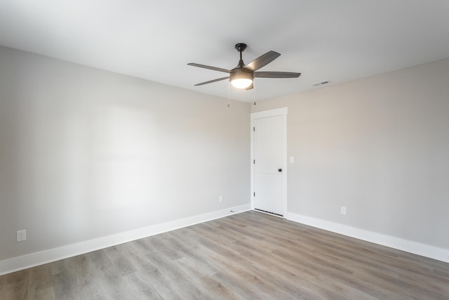 empty room with ceiling fan and light hardwood / wood-style flooring