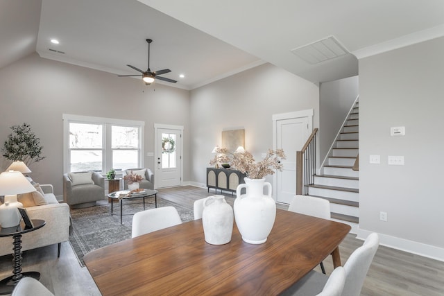 dining area with crown molding and hardwood / wood-style floors