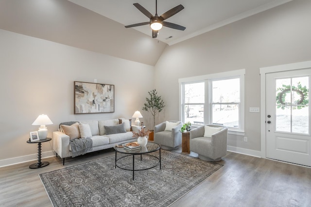 living room with ceiling fan, lofted ceiling, and light hardwood / wood-style floors