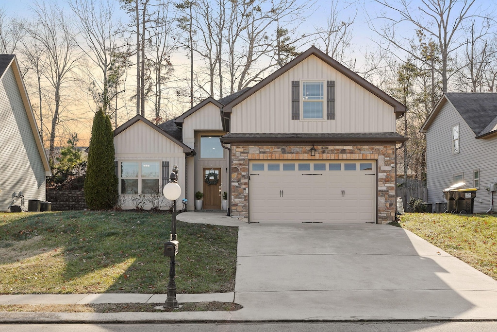 view of front of house with a garage and a yard