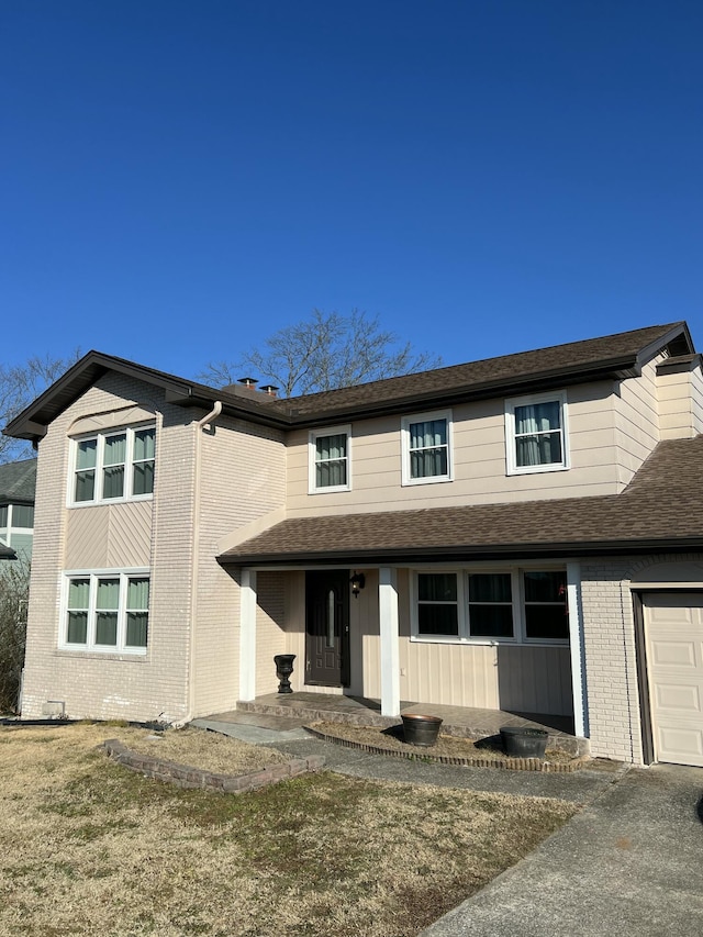 view of front of property with a garage and a front lawn